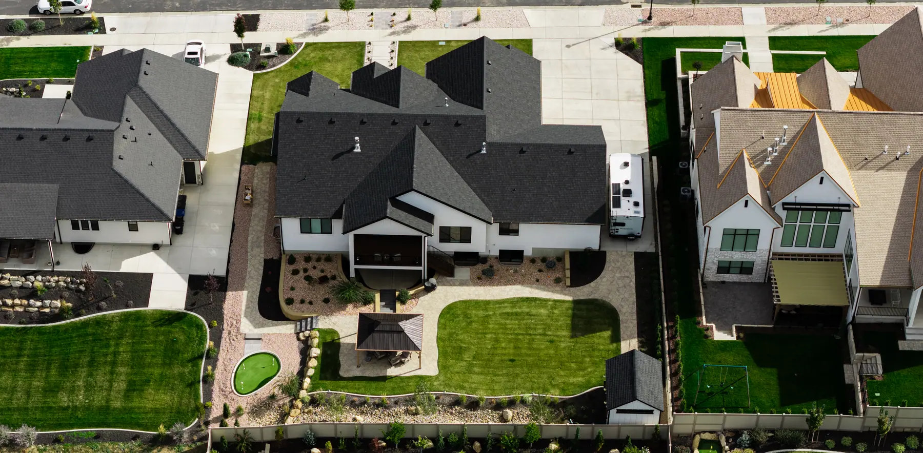 Pavilion, lawn and putting green by J&H Landscaping in Utah County