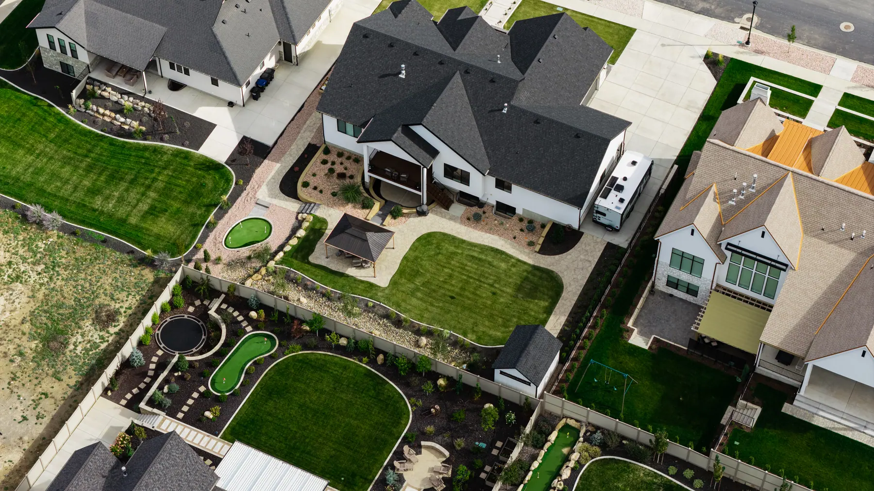 Rock beds and putting greens by J&H Landscaping in Utah County