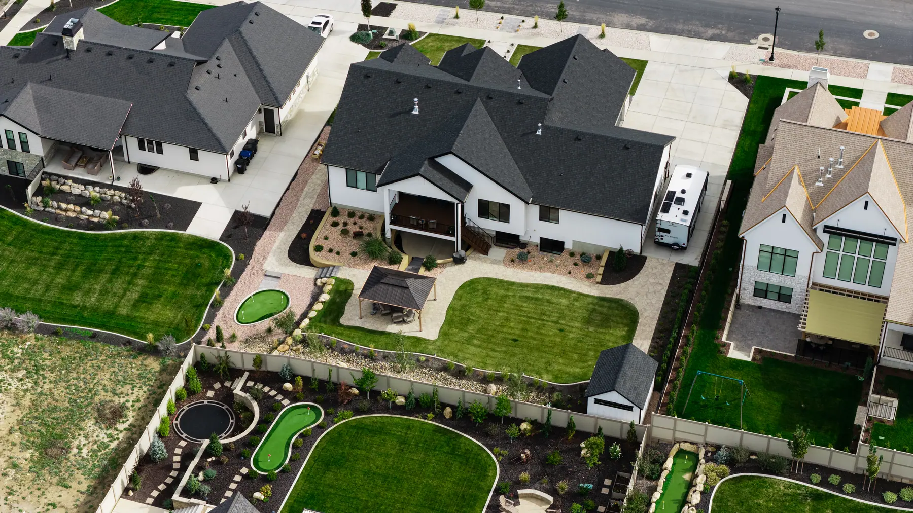 Lawn, pavilion and putting greens by J&H Landscaping in Utah County