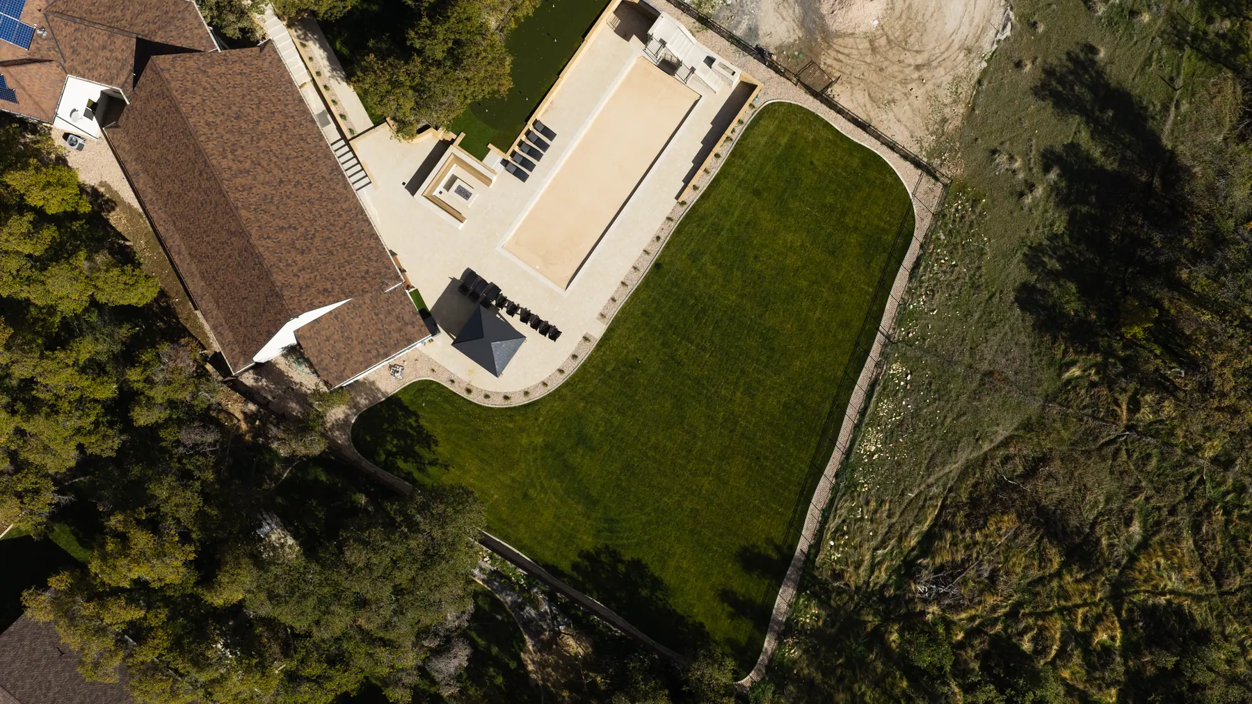 Big lawn and patio from above by J&H Landscaping in Utah County