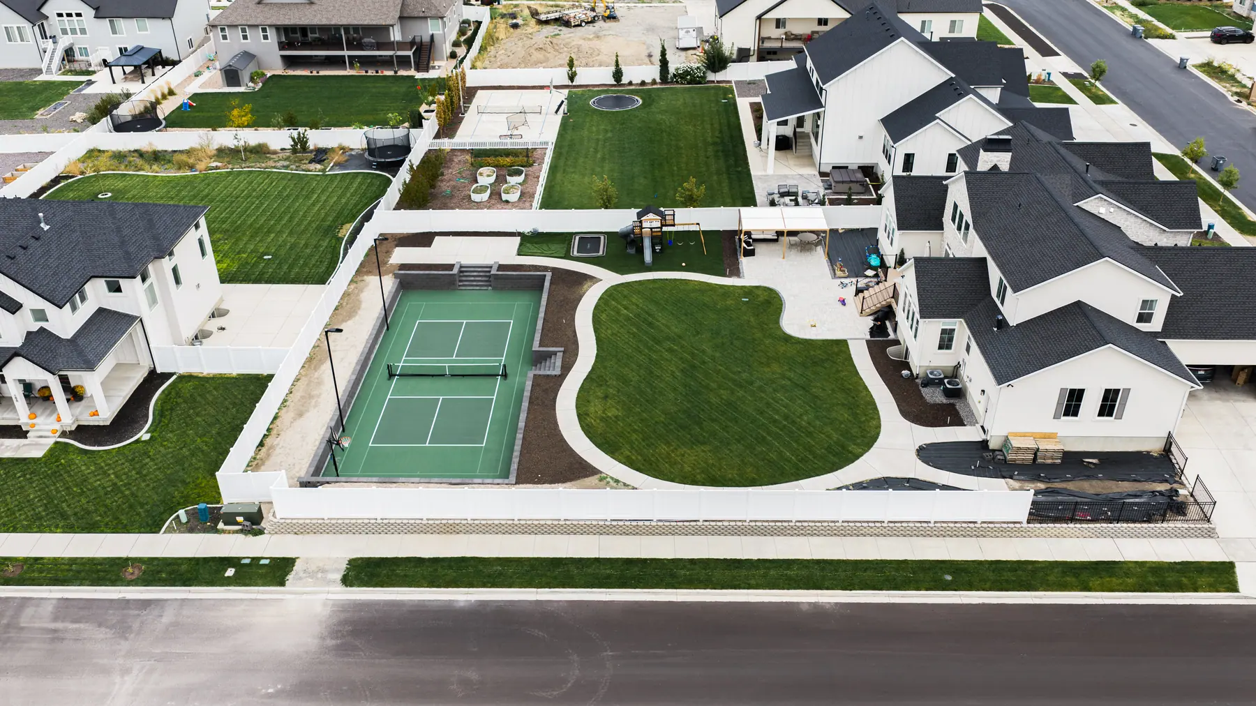 Court and curved lawn from above by J&H Landscaping in Mapleton