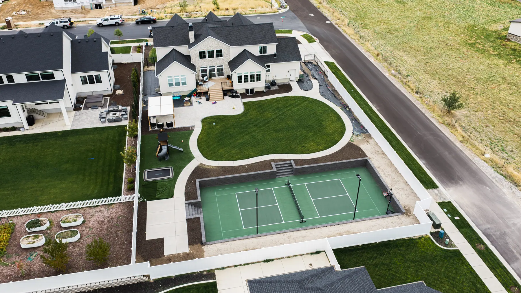 Backyard court and play area by J&H Landscaping in Mapleton