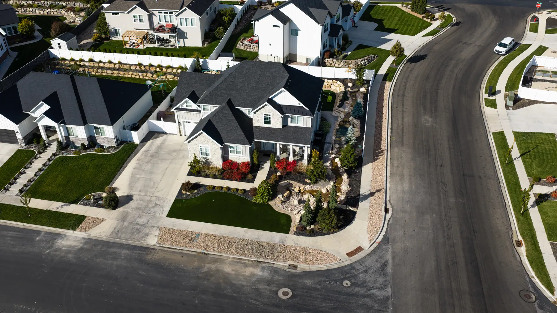 Corner front yard with rock garden by J&H Landscaping in American Fork