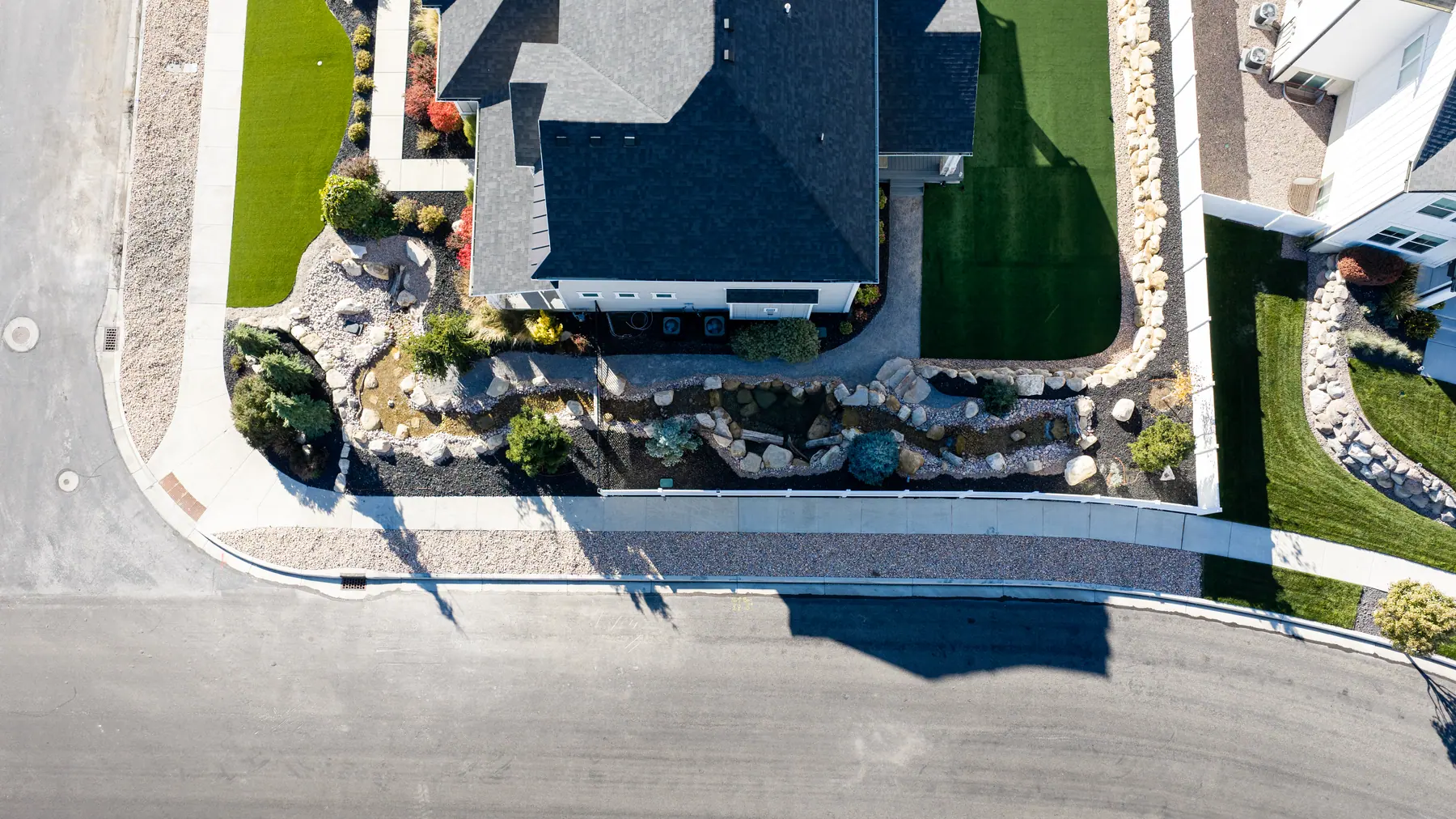 Dry creek bed and boulders by J&H Landscaping in American Fork