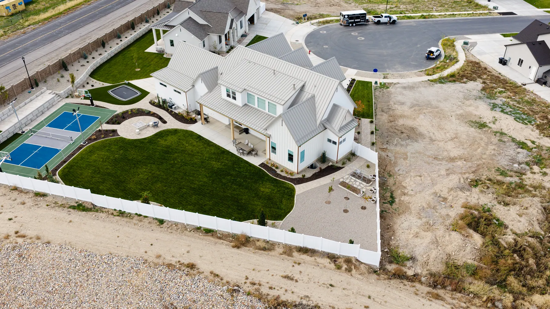 Backyard lawn and court by J&H Landscaping in Utah County