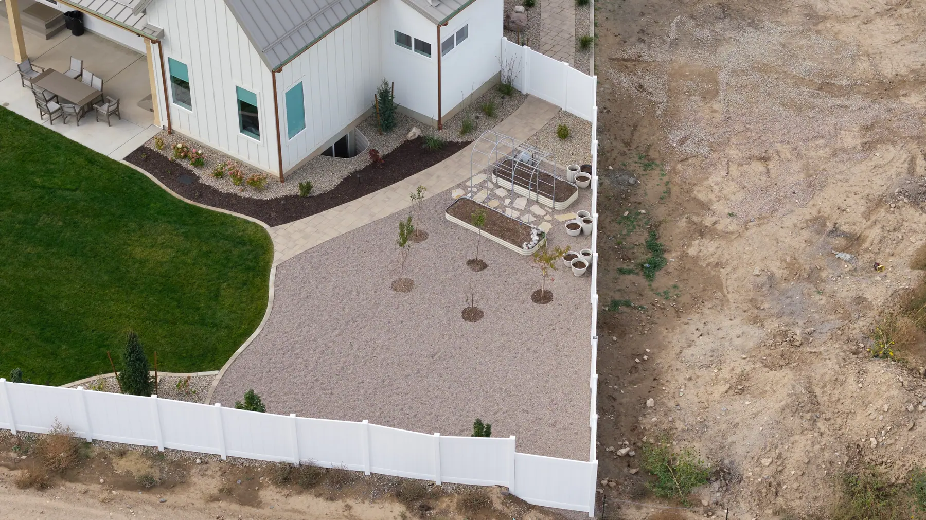 Backyard rock and lawn by J&H Landscaping in Utah County