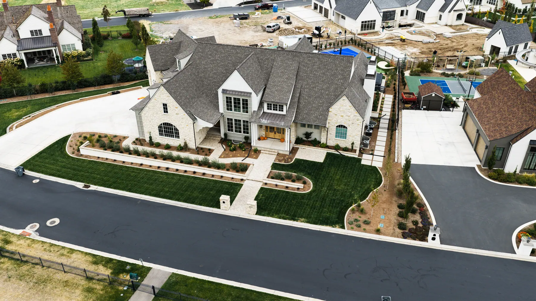 Front lawn and stone-edged beds by J&H Landscaping in Mapleton