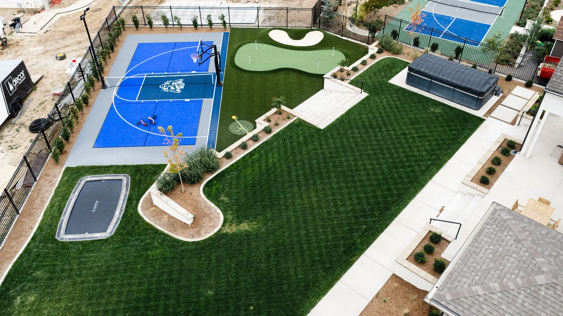 Basketball court and big lawn by J&H Landscaping in Mapleton