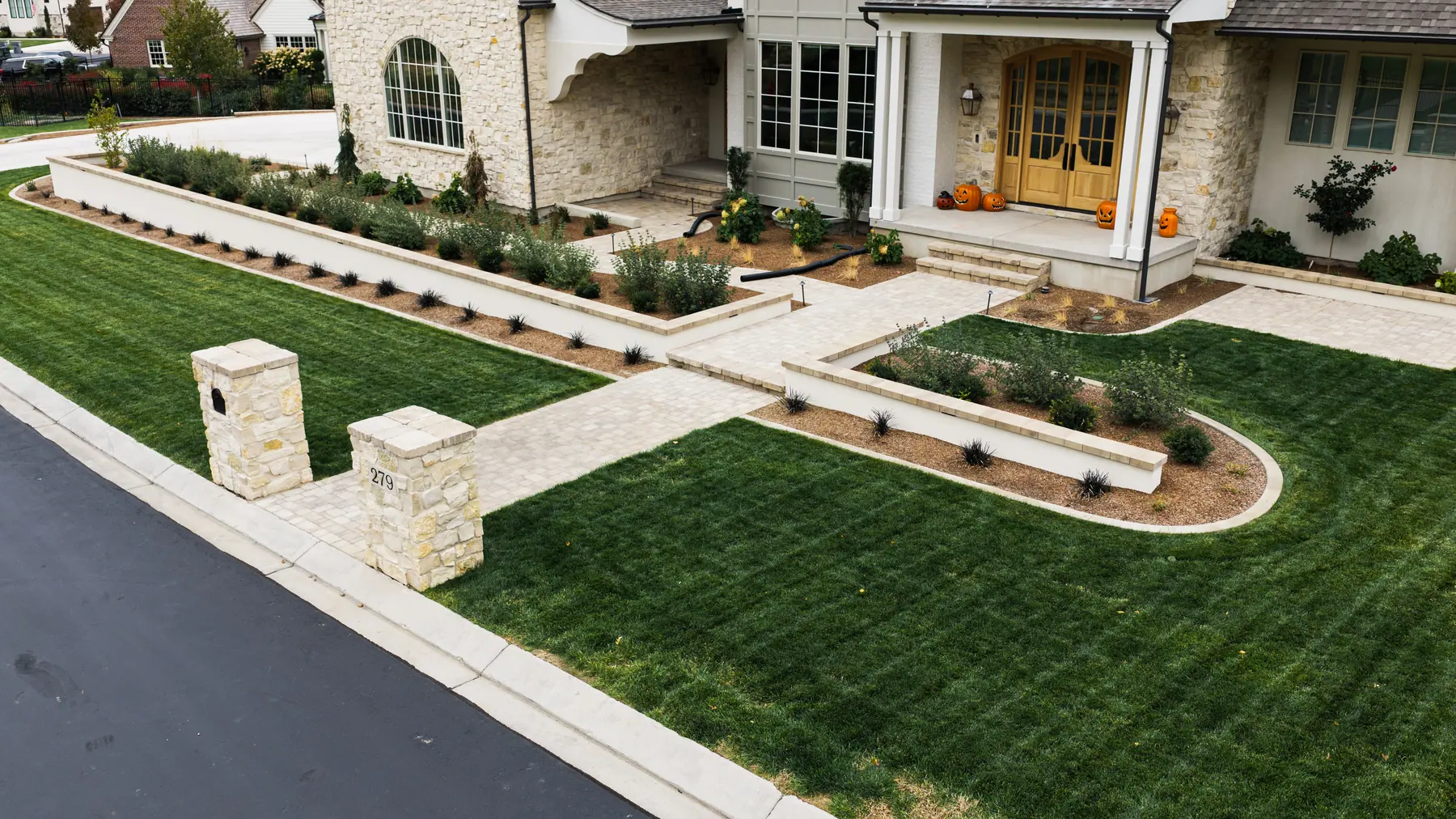 Stone pillars and front walk by J&H Landscaping in Mapleton