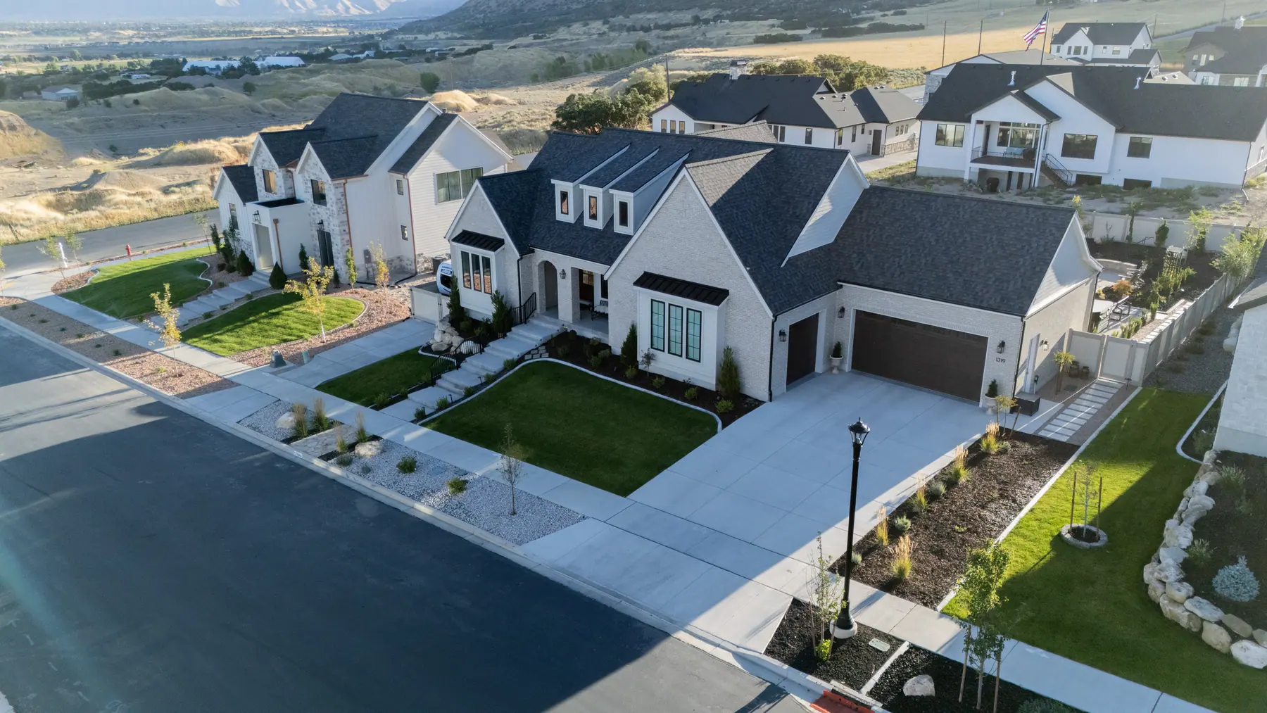New-build front yard at dusk by J&H Landscaping in Salem
