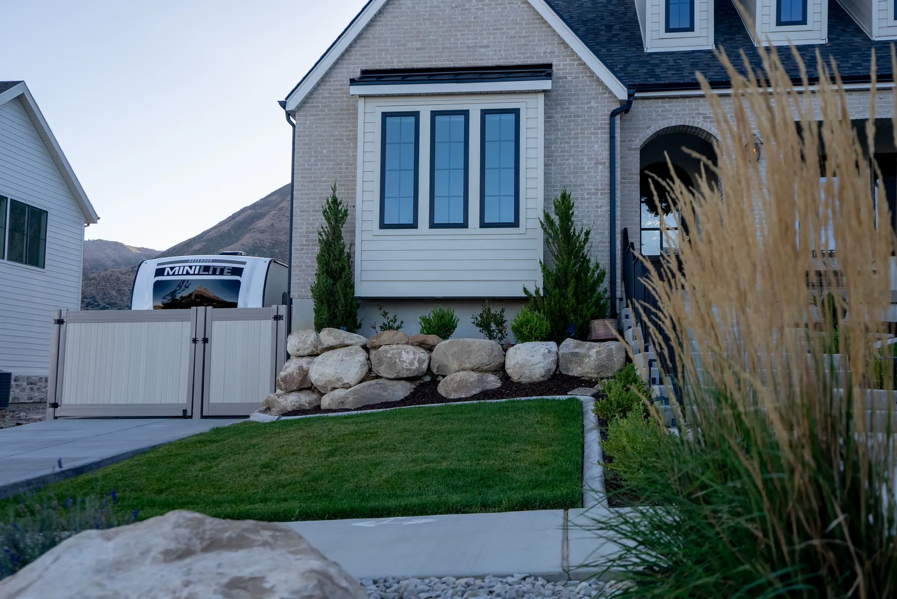 Boulder accents and front lawn by J&H Landscaping in Salem
