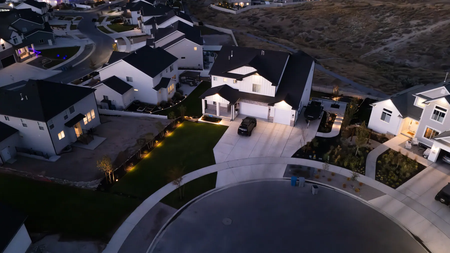 Front yard lighting at dusk by J&H Landscaping in Saratoga Springs