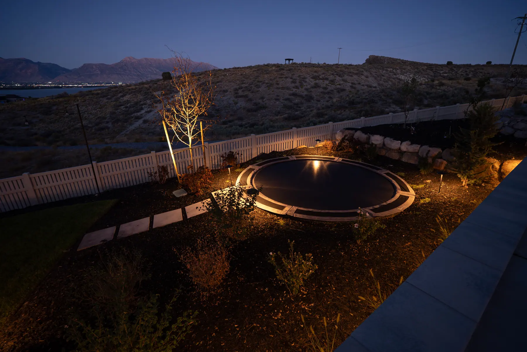 Lit fire pit area by J&H Landscaping in Saratoga Springs