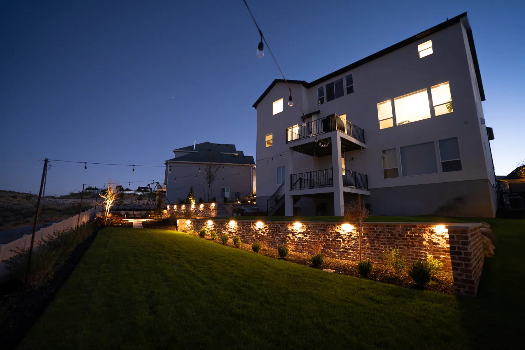 Lit block retaining wall by J&H Landscaping in Saratoga Springs
