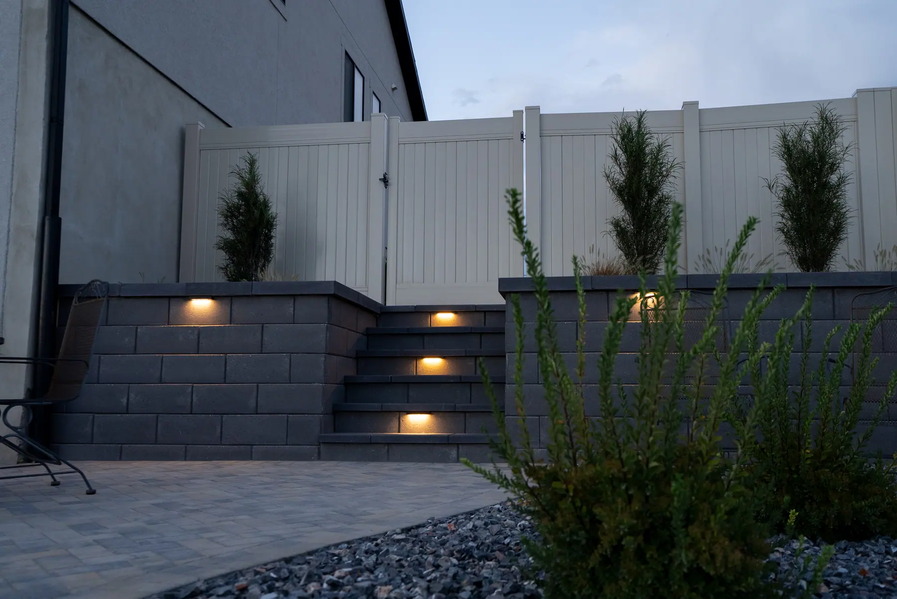 Lit steps in a block wall by J&H Landscaping in Saratoga Springs