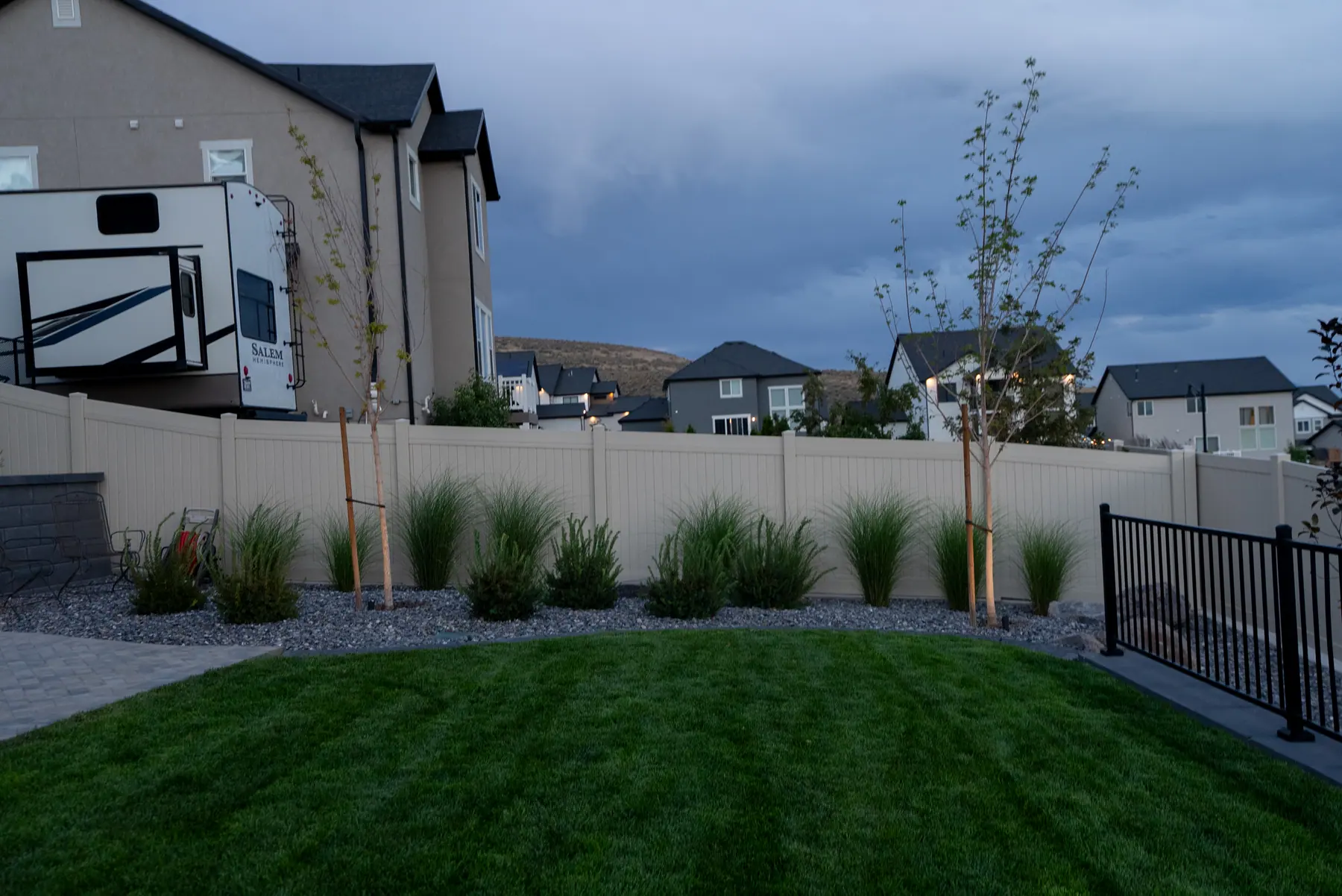 Backyard lawn and plantings by J&H Landscaping in Saratoga Springs