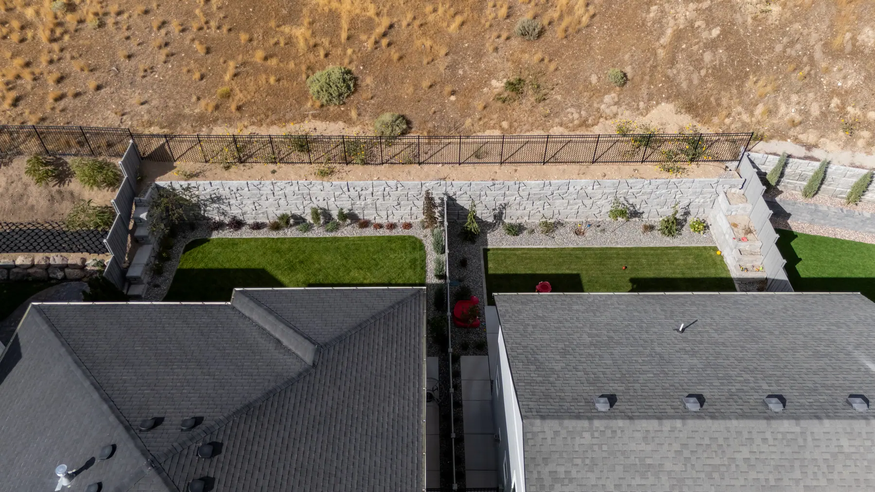 Side-yard planting by a hill by J&H Landscaping in Lehi