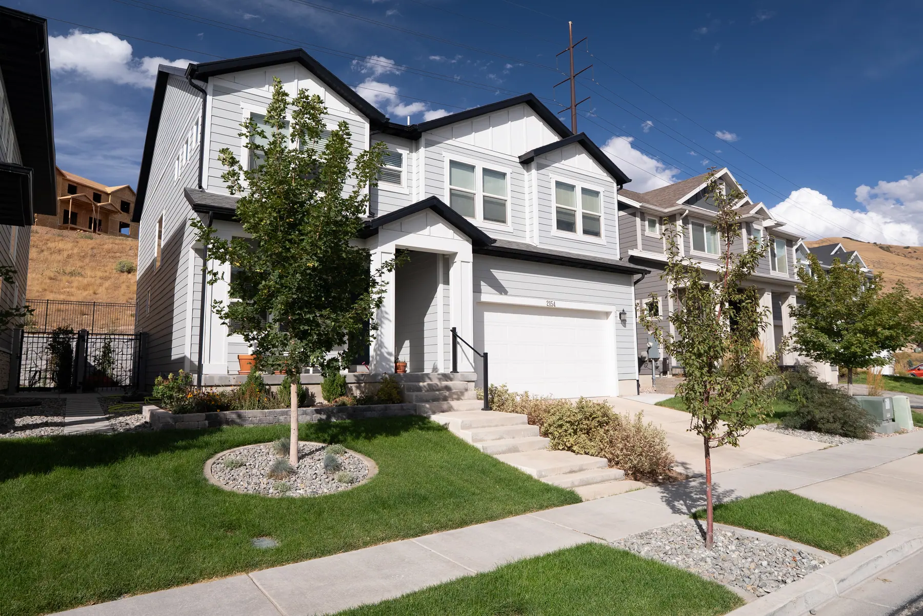 Front lawn and tree ring by J&H Landscaping in Lehi