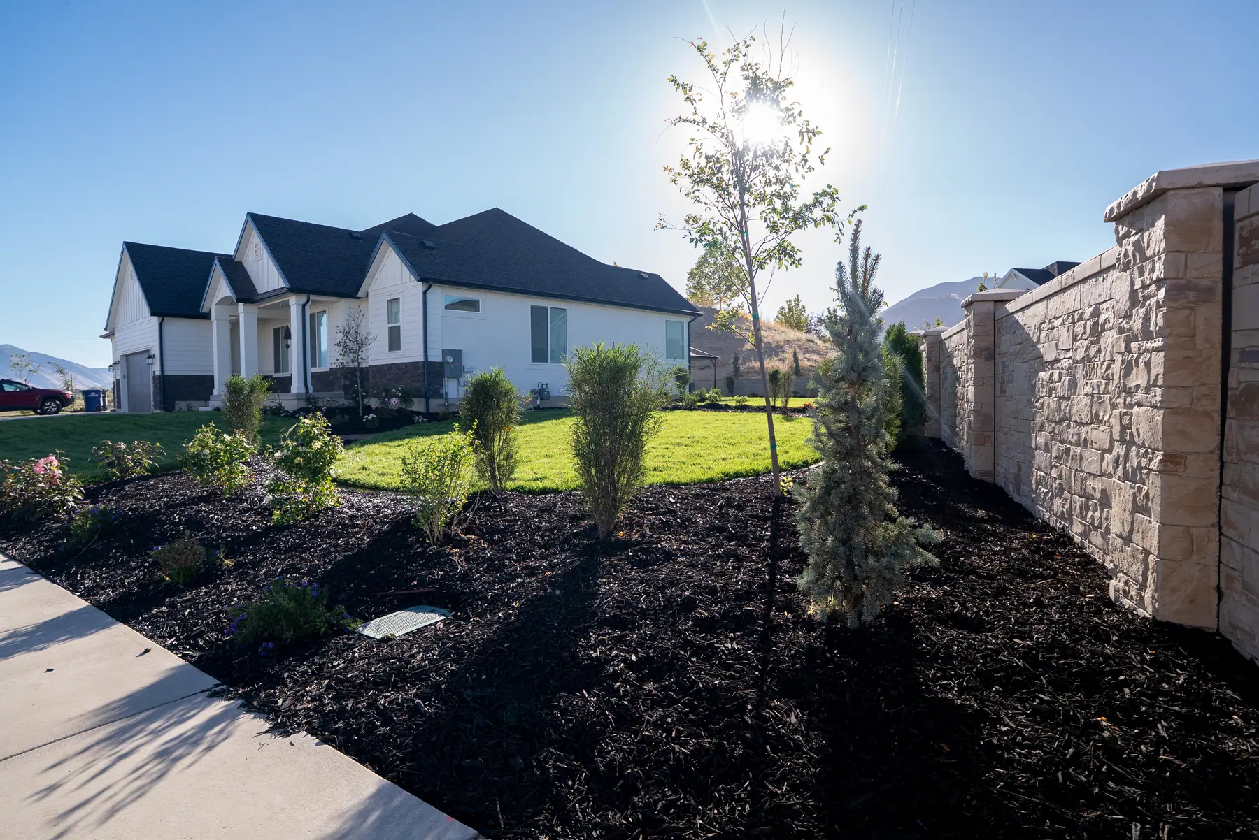 Stone wall and new beds by J&H Landscaping in Spanish Fork