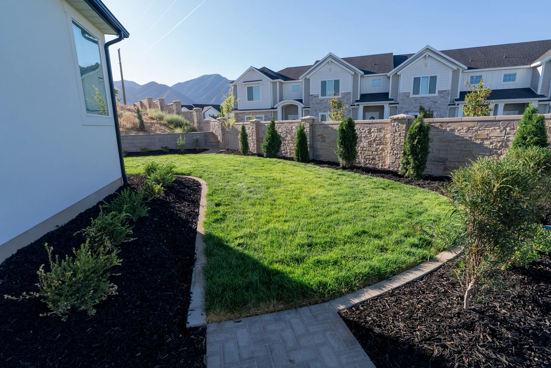 Curved lawn and paver edge by J&H Landscaping in Spanish Fork