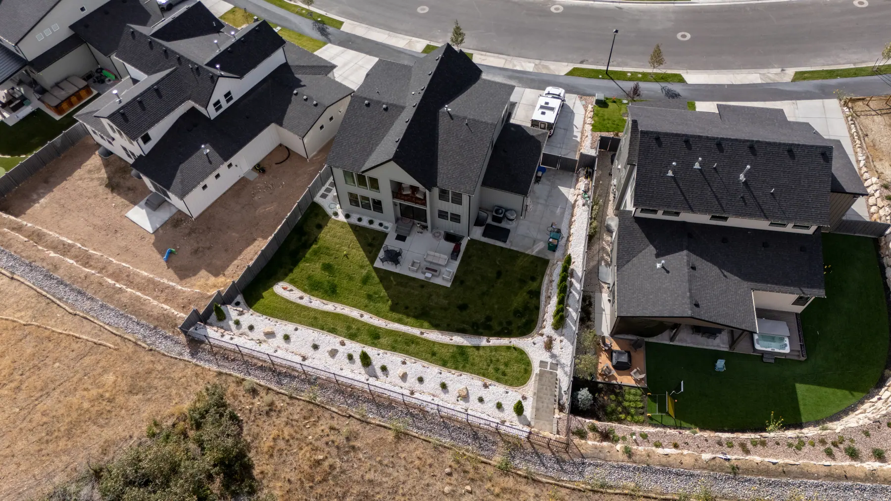Rock walls and backyard from above by J&H Landscaping in Lehi