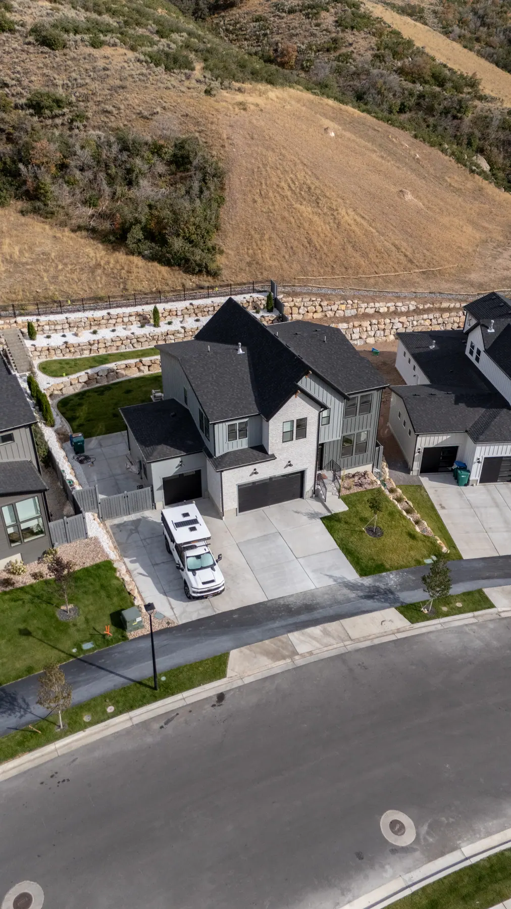 Boulder walls up the slope by J&H Landscaping in Lehi
