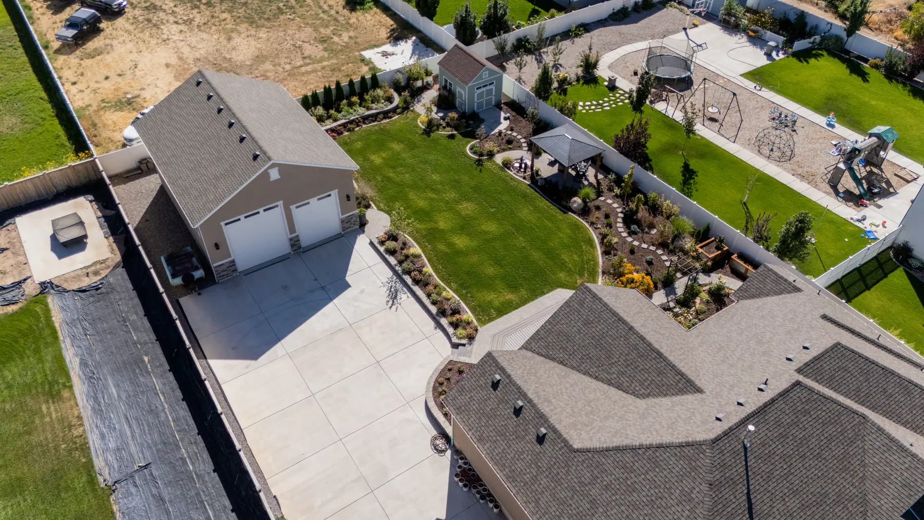 Lawn, beds and garage from above by J&H Landscaping in Mapleton