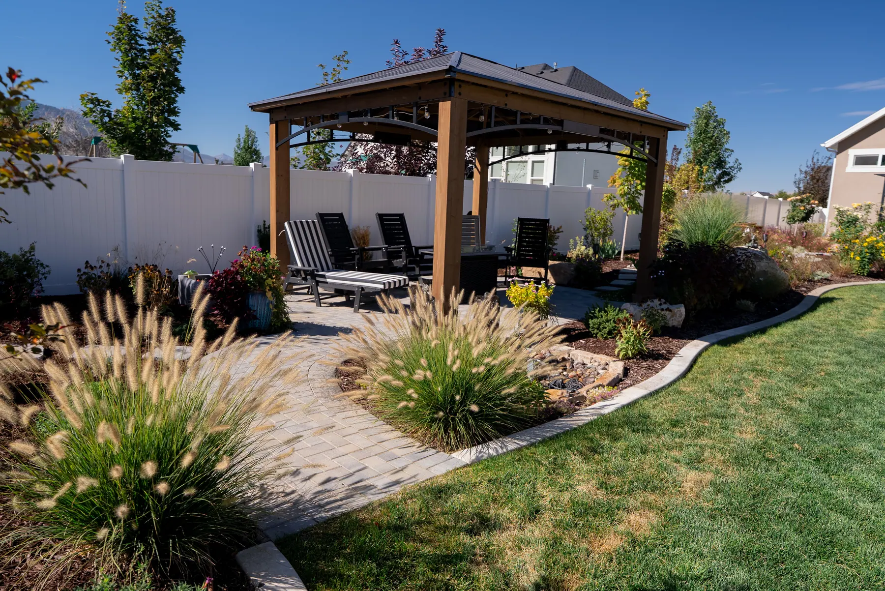 Pavilion with ornamental grasses by J&H Landscaping in Mapleton