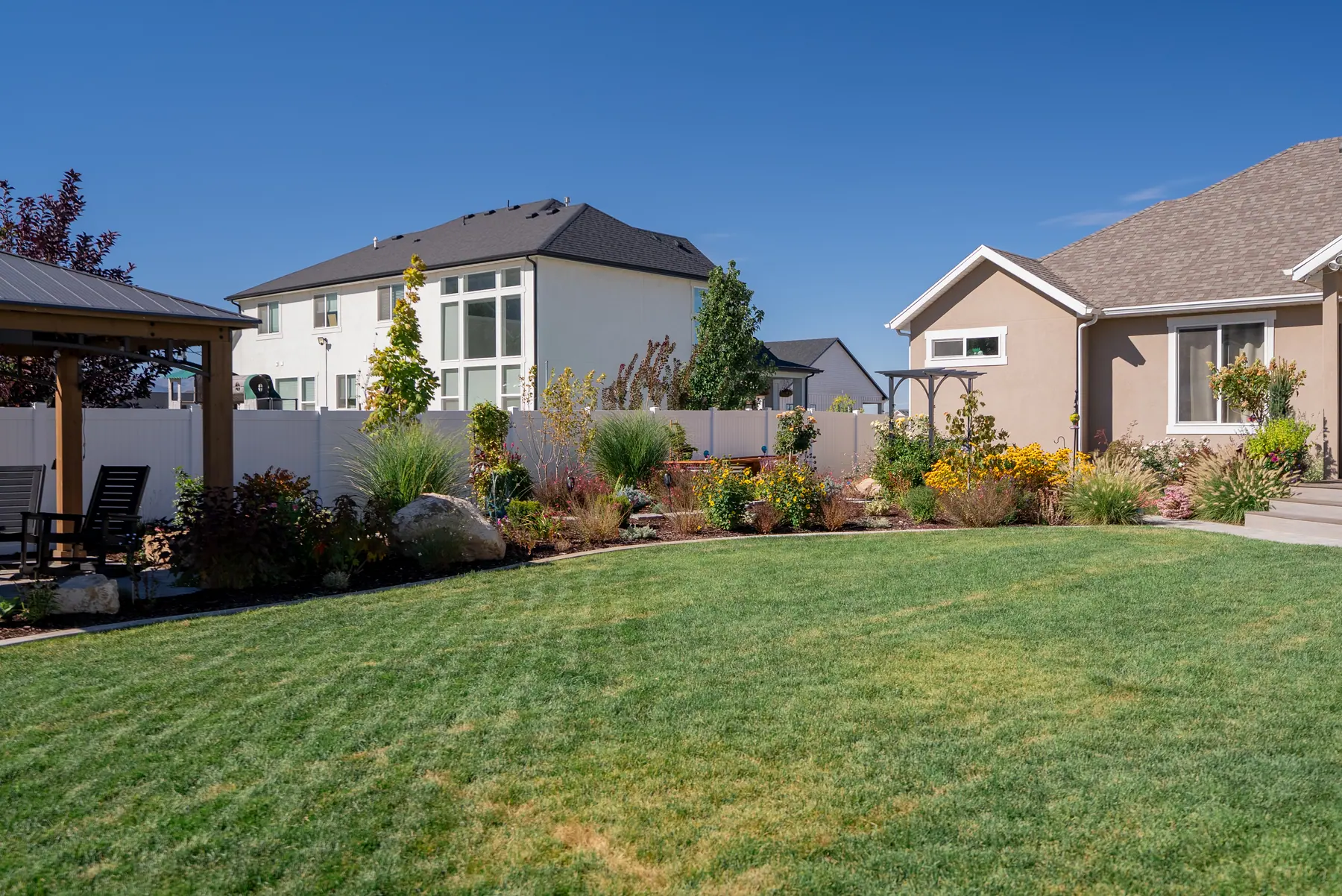 Backyard lawn and beds by J&H Landscaping in Mapleton
