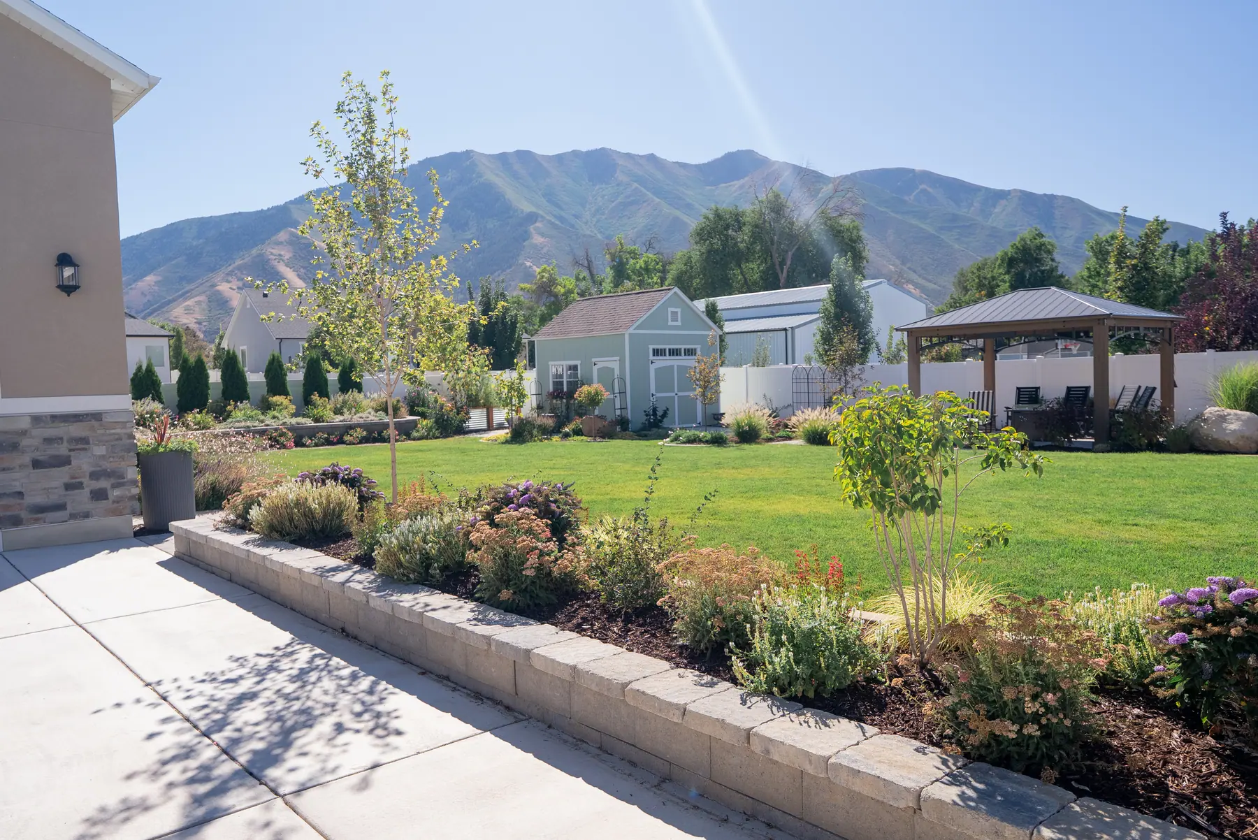 Lawn and beds under the mountains by J&H Landscaping in Mapleton