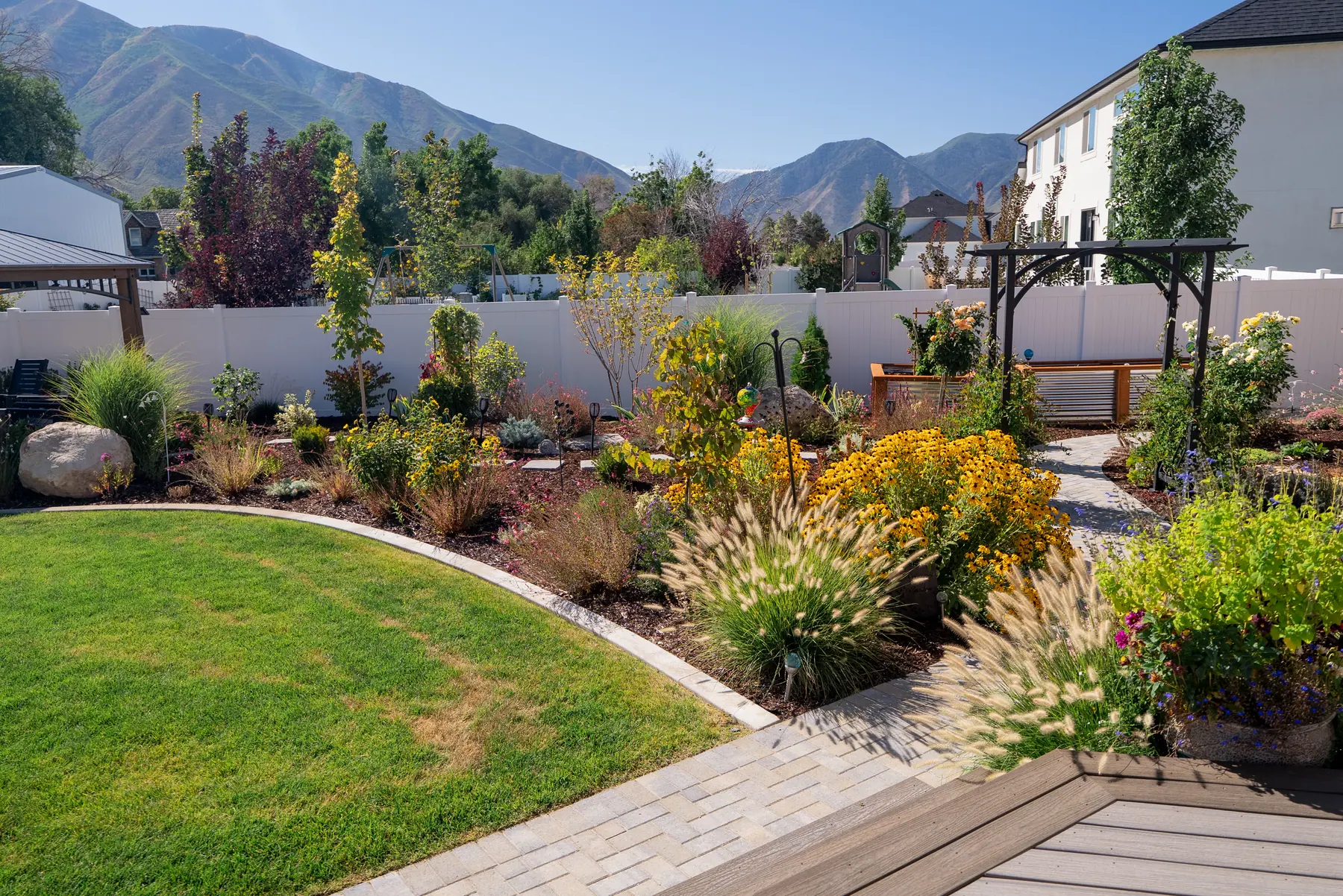 Paver walk and perennial beds by J&H Landscaping in Mapleton