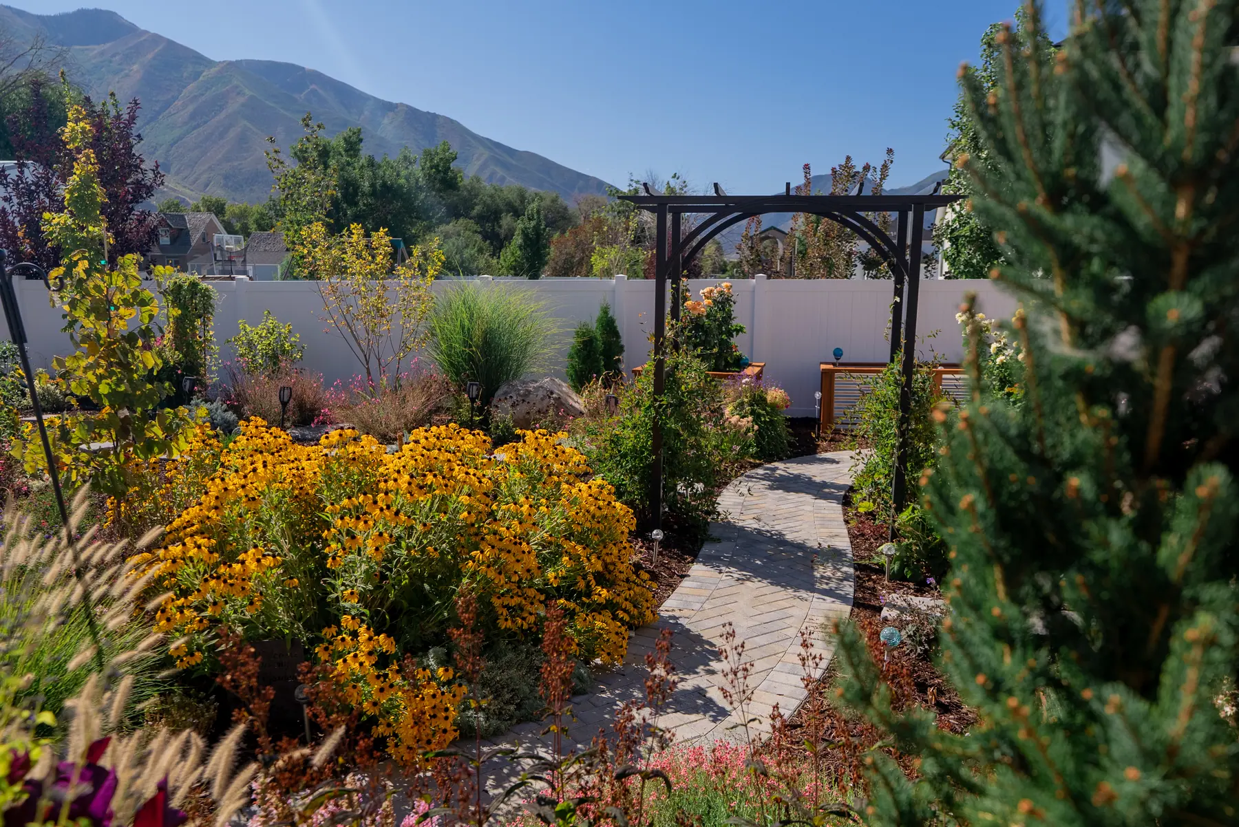Garden arbor and paver path by J&H Landscaping in Mapleton