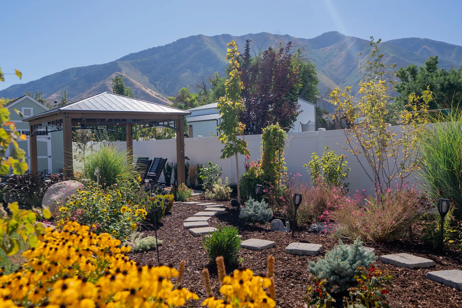 Pavilion and perennial garden by J&H Landscaping in Mapleton