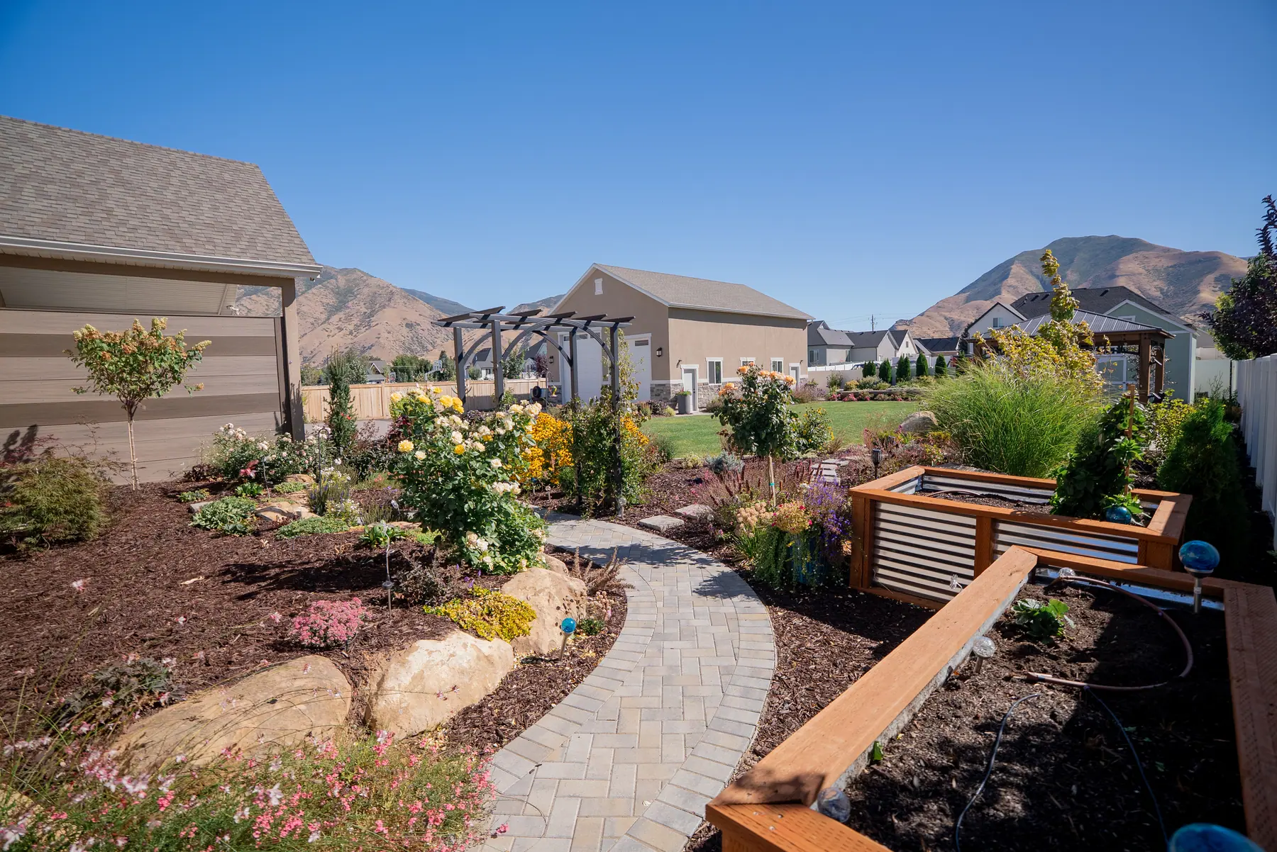 Paver path and raised beds by J&H Landscaping in Mapleton