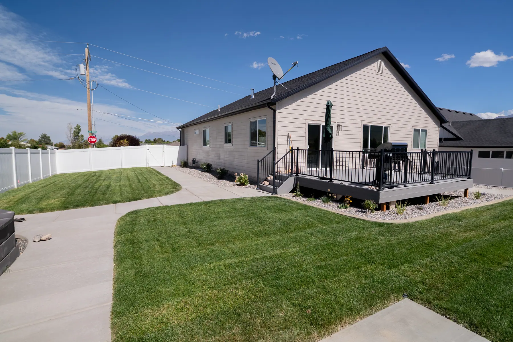 Side yard lawn and deck by J&H Landscaping in Payson