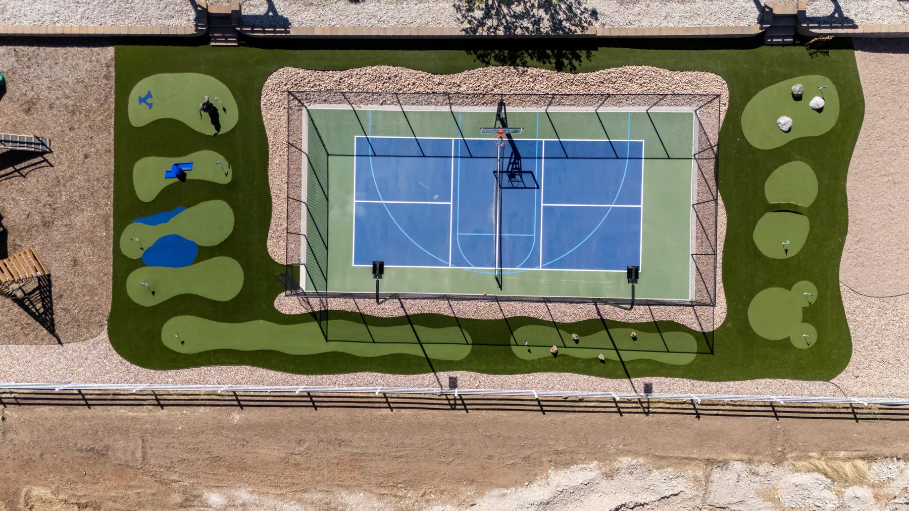 Court and putting green from above by J&H Landscaping in Elk Ridge