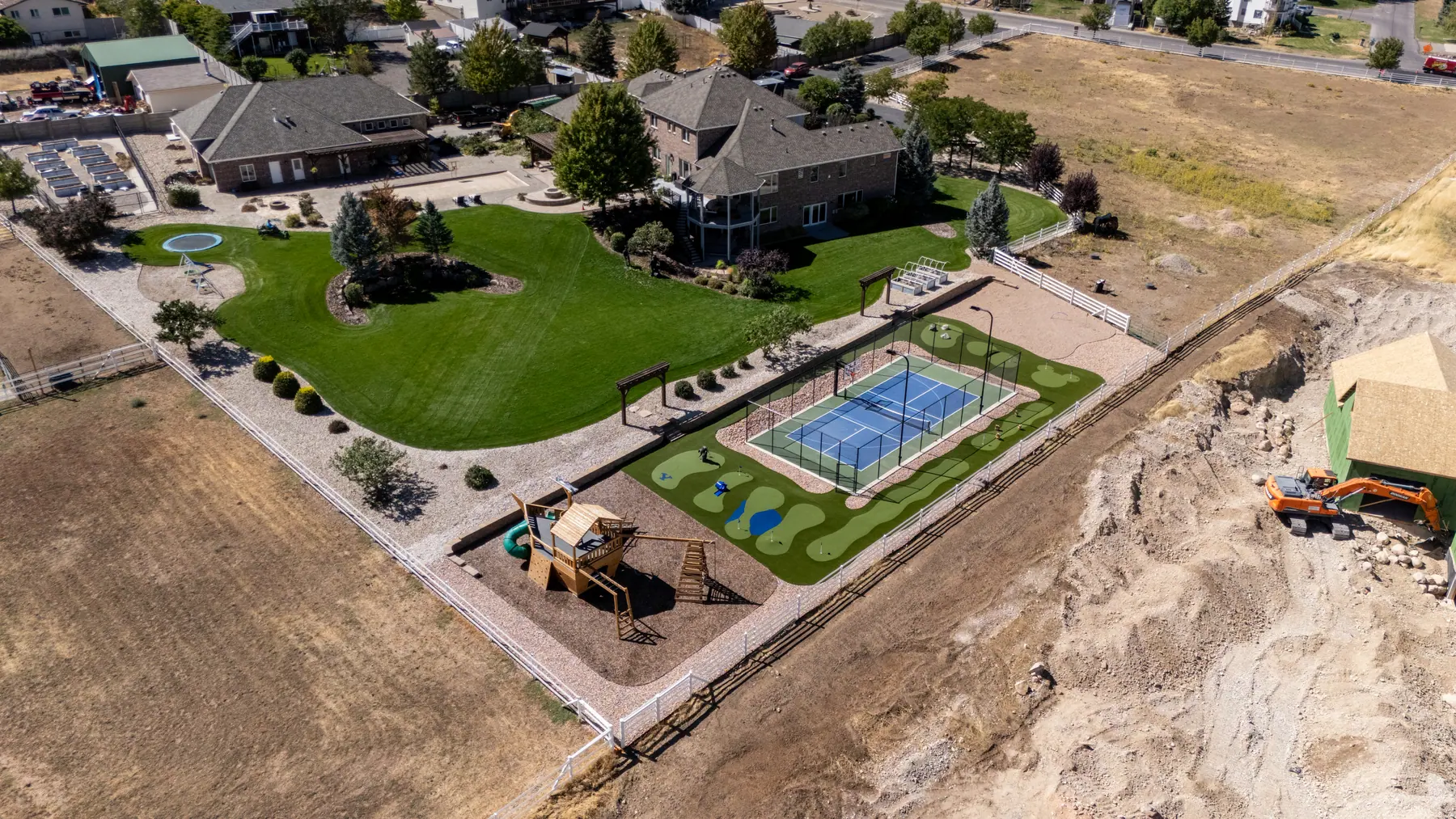 Backyard court and lawn from above by J&H Landscaping in Elk Ridge