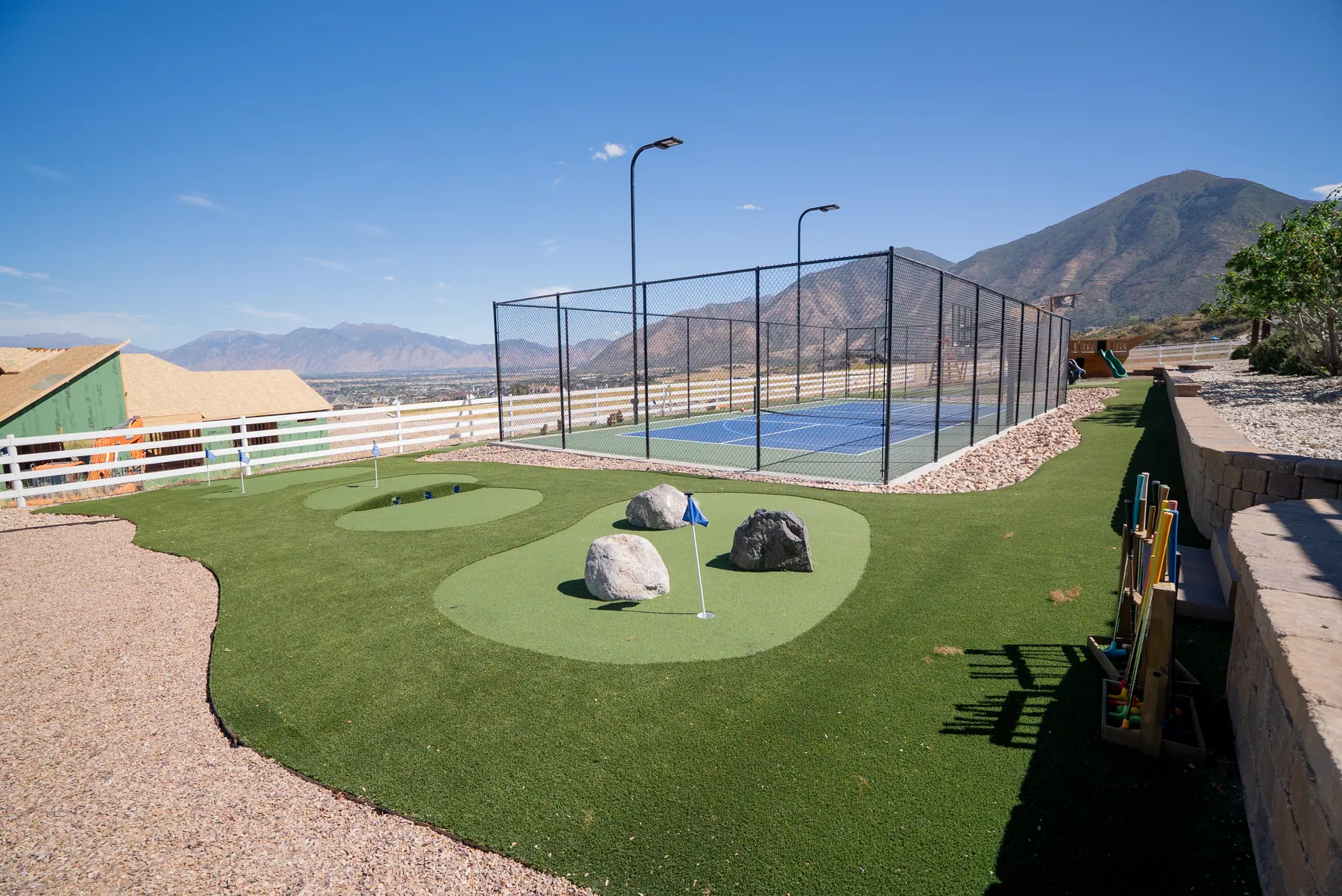 Putting green with mountain views by J&H Landscaping in Elk Ridge