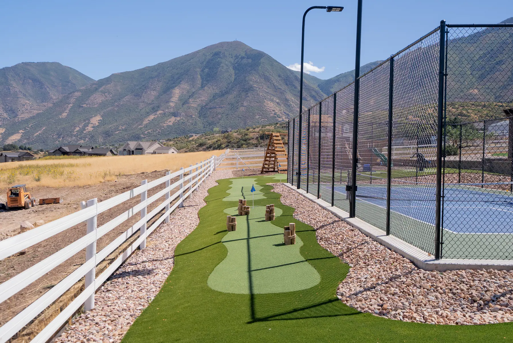Turf path and court under the mountains by J&H Landscaping in Elk Ridge