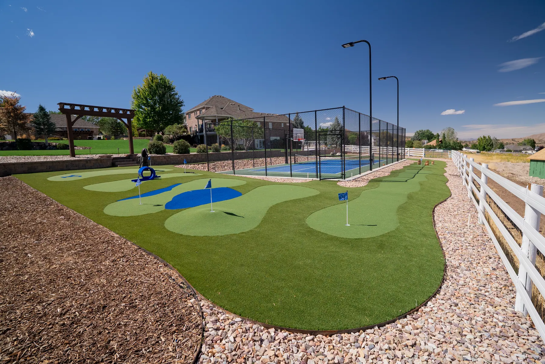 Putting green and sport court by J&H Landscaping in Elk Ridge
