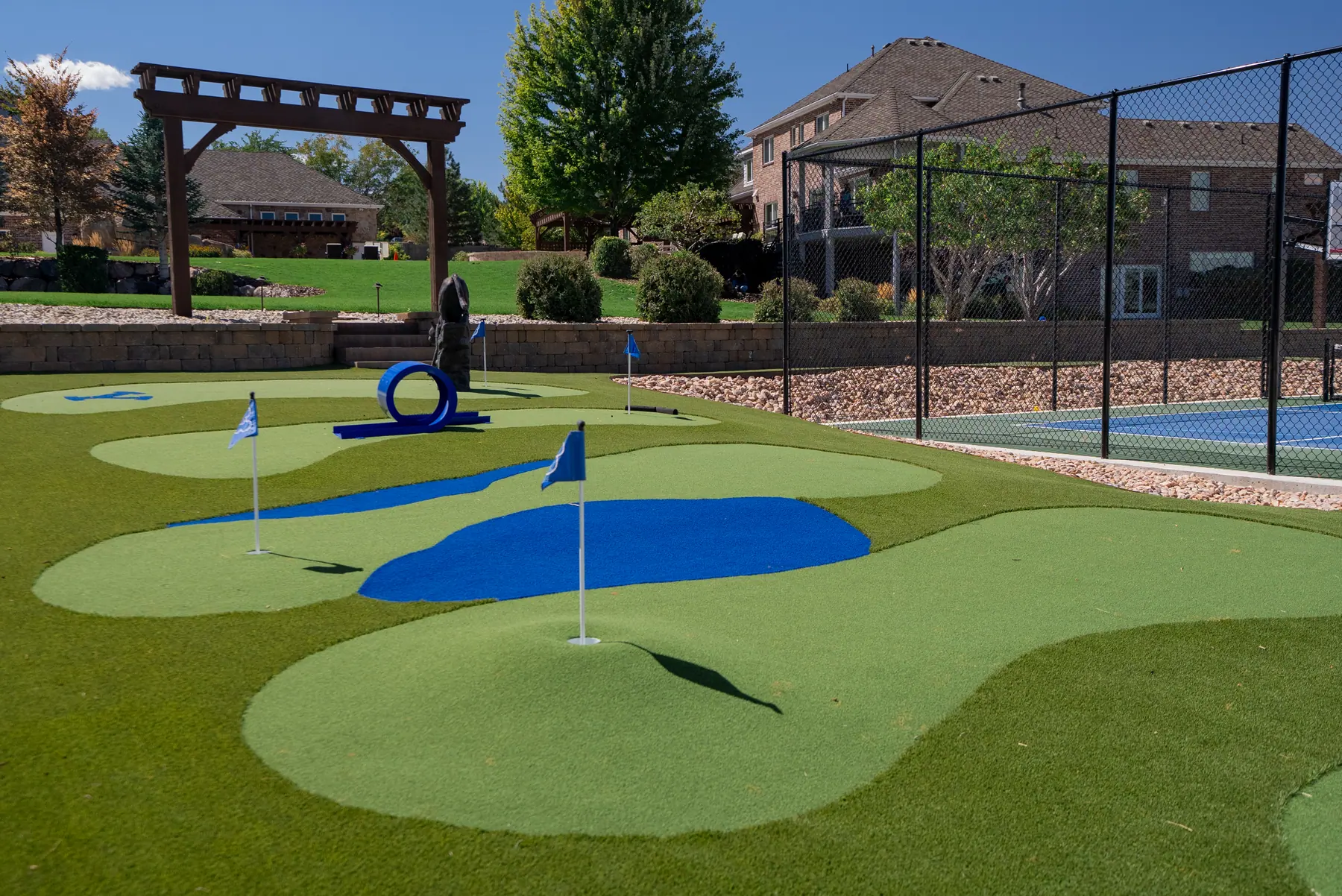 Putting greens by the court by J&H Landscaping in Elk Ridge