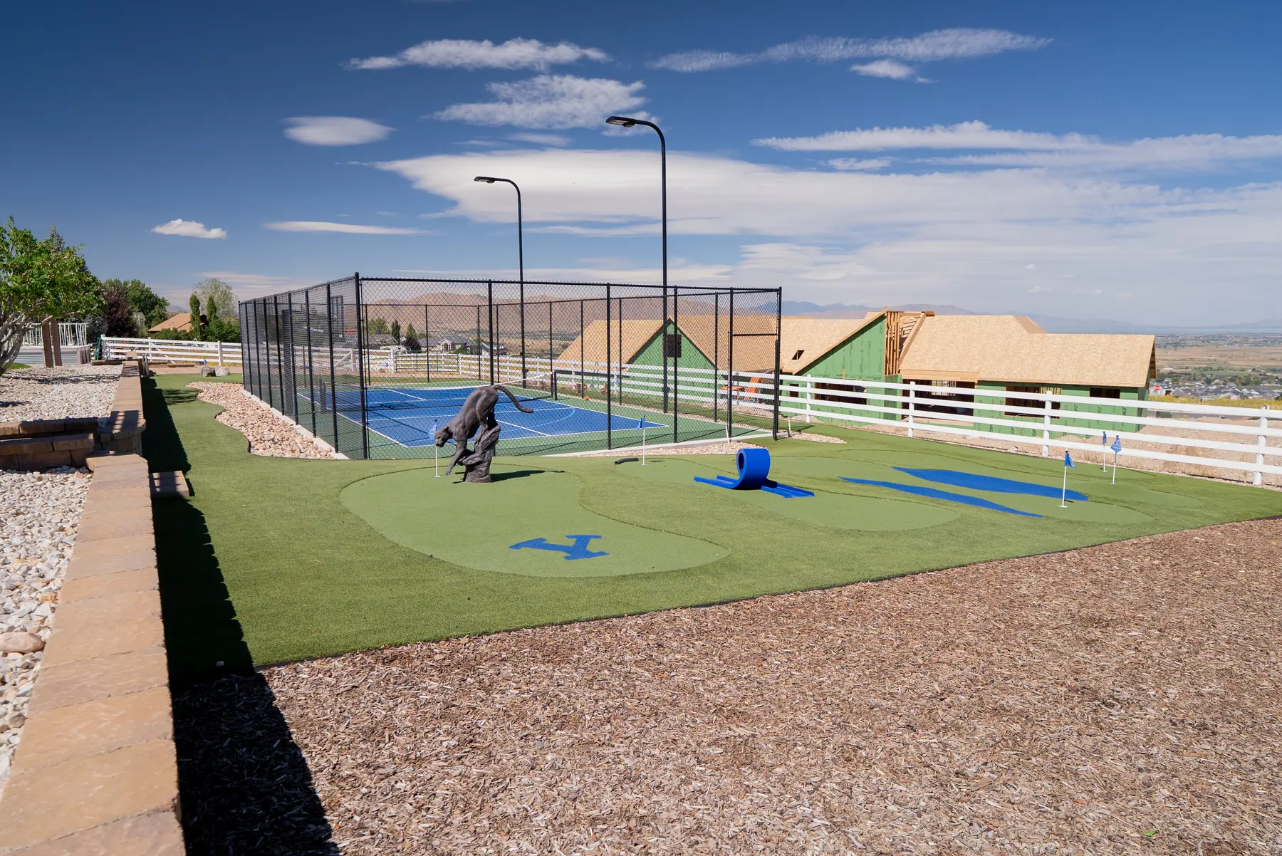 Custom putting course by the court by J&H Landscaping in Elk Ridge