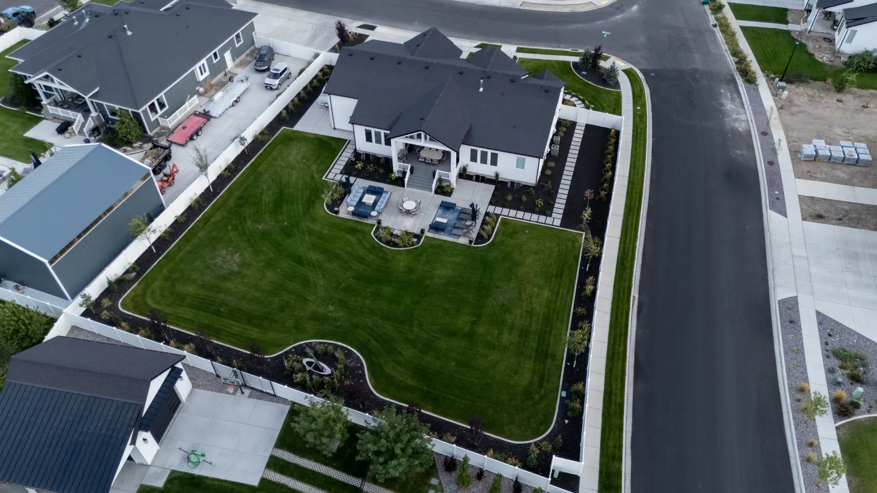 Big backyard with fire pit patio by J&H Landscaping in Utah County