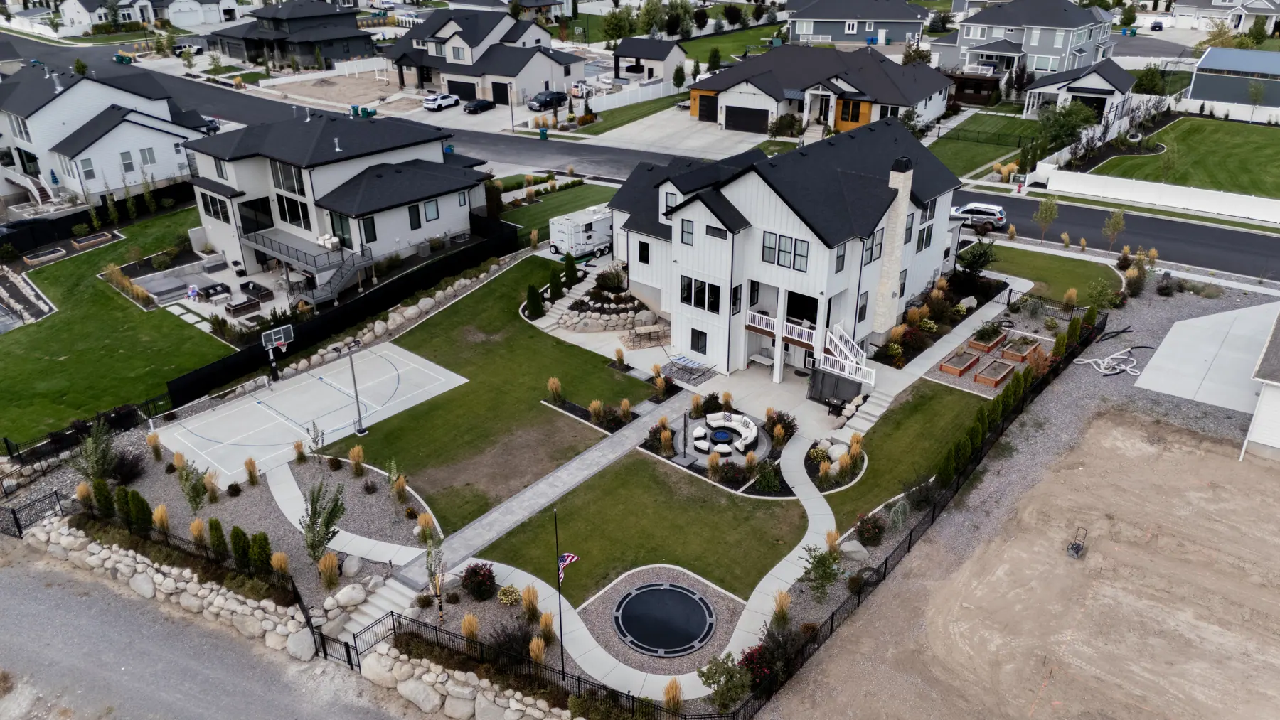 Backyard with play area and patio by J&H Landscaping in Utah County