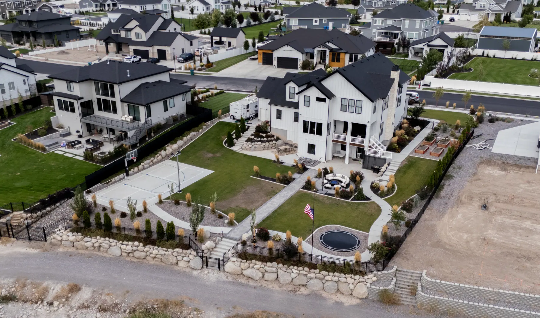 Backyard with play area and patio by J&H Landscaping in Utah County