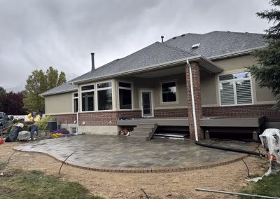 Backyard patio installation with stone pavers and landscaping elements, showcasing J&H Landscaping's work in Provo, UT.